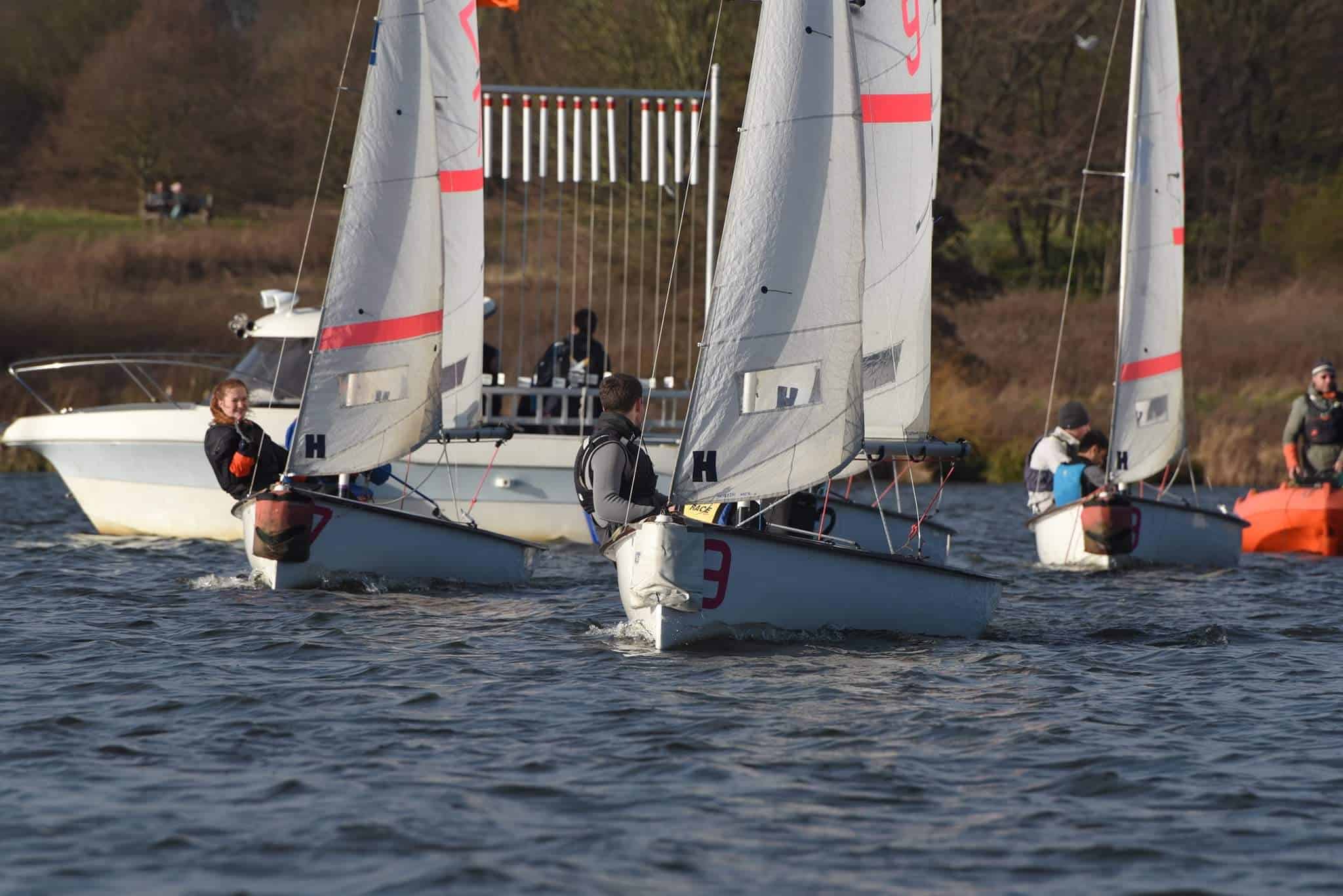 Three Fireflies of the Cambridge Beige Team sail off the line at the 2022 Imperial Icicle