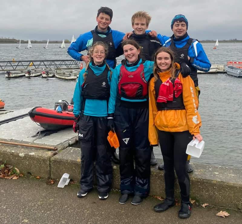 Team sailors posing for a photo at the 2025 Oxford Magnum with the reservoir in the background